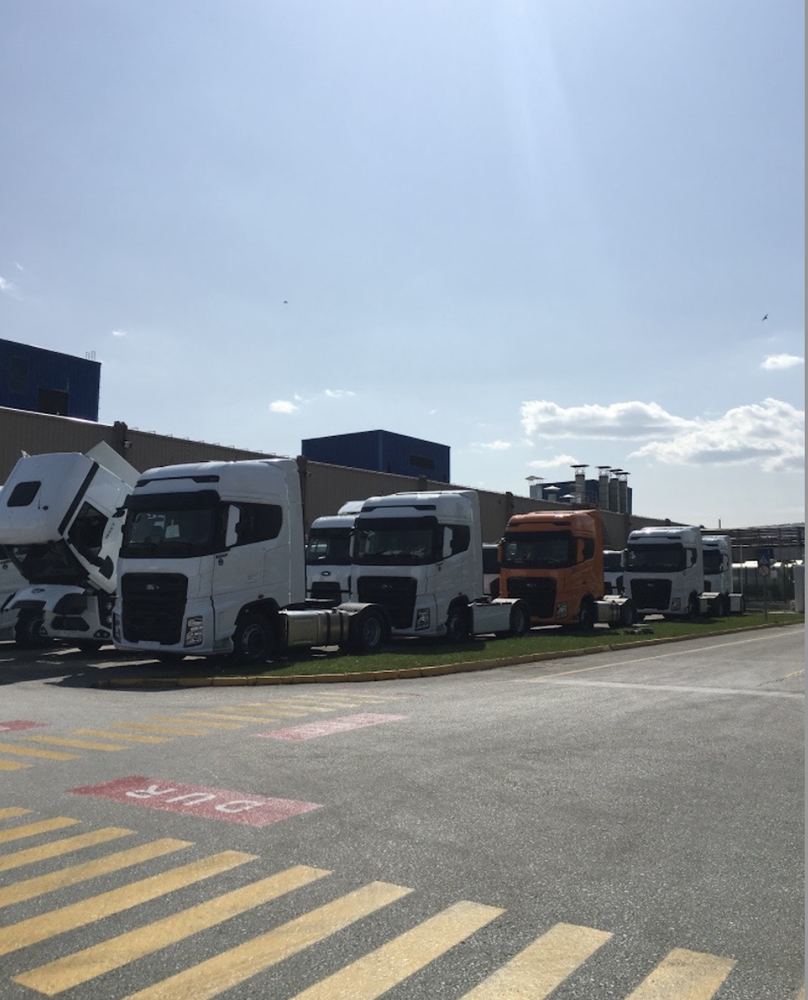 A row of Ford Trucks FMax tractor units parked outside the plant.