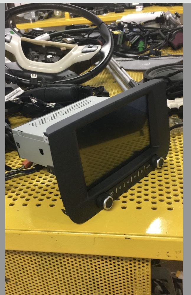 A vehicle multimedia head unit on a test bench.